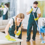 Cleaning service employees with professional equipment cleaning a private home after renovation